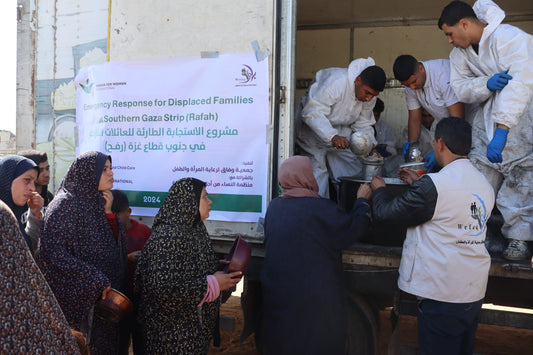 Women line up to receive food aid in Rafah